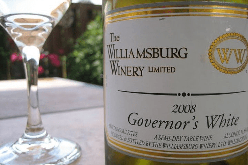 White wine bottle with stemmed wine glass